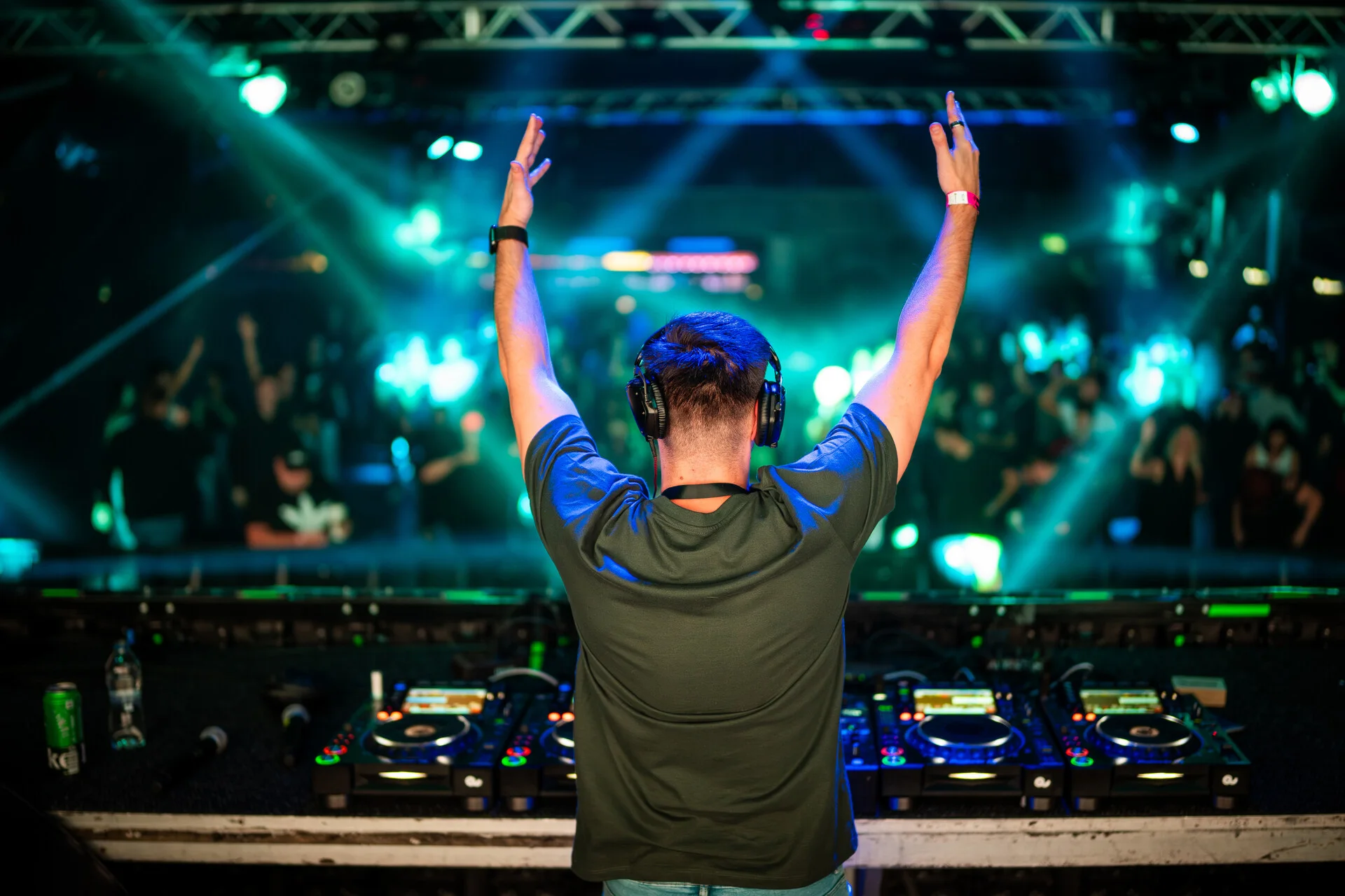 Subrage facing the crowd from the DJ booth during Hardstyle Revolution